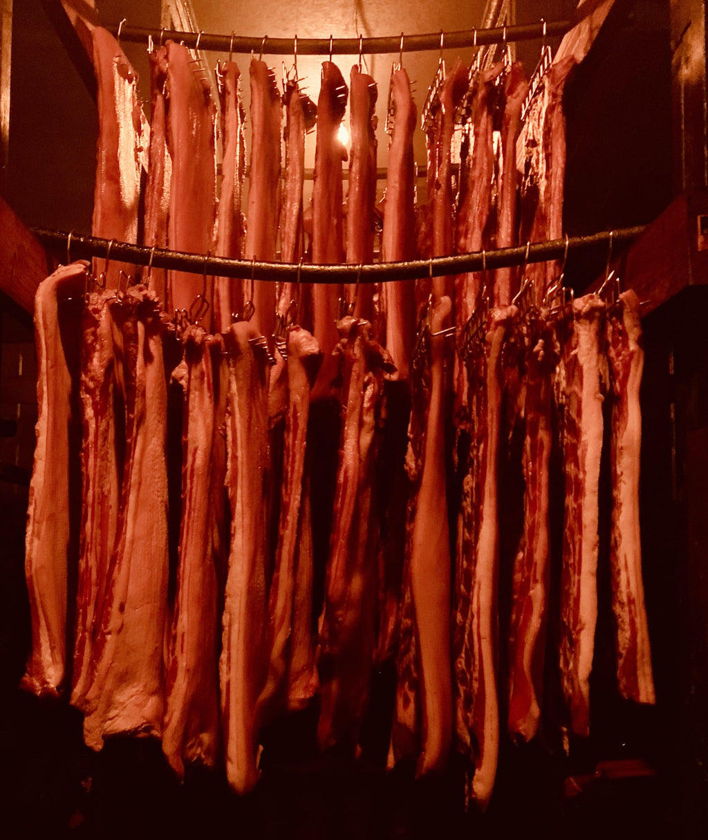 Hickory Bacon hanging in our smokehouse